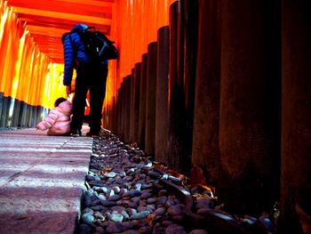 Rear view of woman with child in torii gate