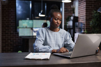 Businesswoman working on laptop in office