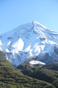 Scenic view of snowcapped mountains against clear blue sky