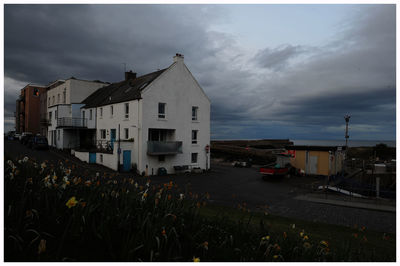 Houses against sky at dusk