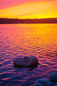 Scenic view of lake at sunset