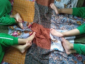 High angle view of siblings lying on floor