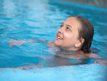 Portrait of smiling girl swimming in pool