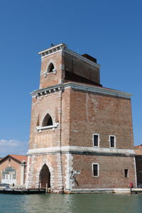 Tower at arsenale against blue sky 