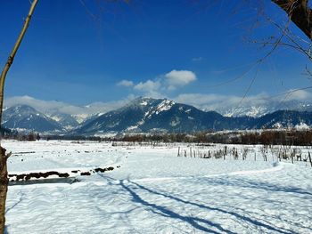 Scenic view of snow covered mountains against sky