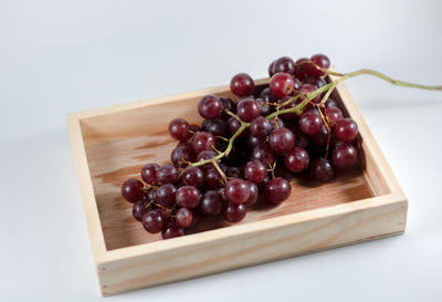 High angle view of grapes in container on table