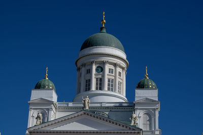 Low angle view of building against clear blue sky