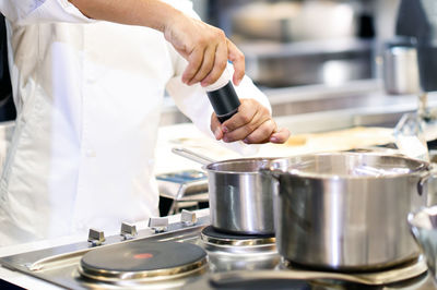 Midsection of man preparing food in kitchen