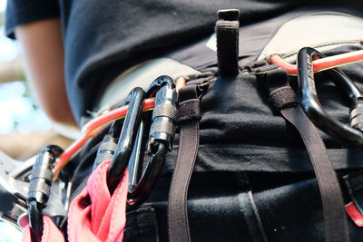 Midsection of person wearing climbing equipment