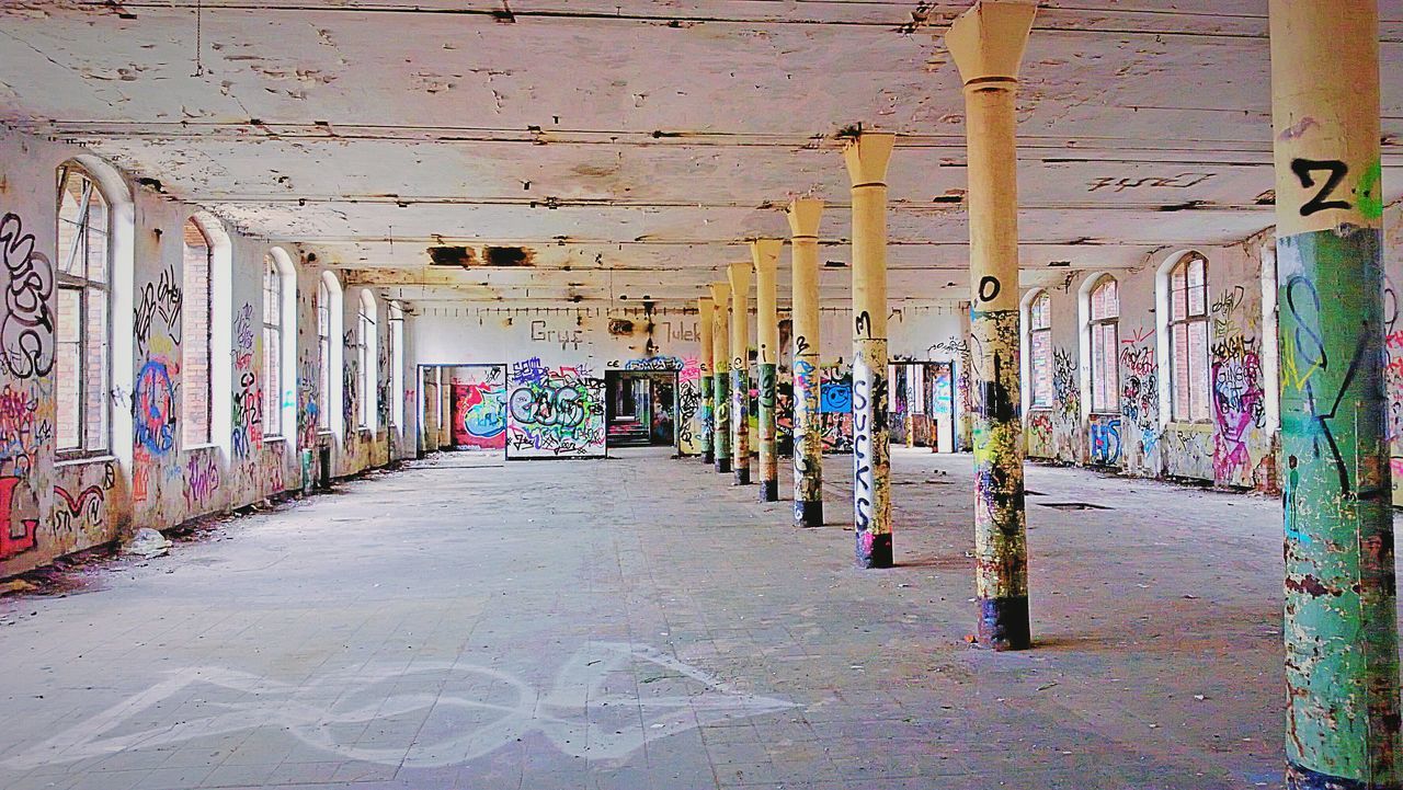 architecture, built structure, graffiti, wall - building feature, building exterior, art, multi colored, art and craft, wall, creativity, street art, building, messy, the way forward, vandalism, abandoned, day, store, indoors, no people