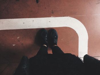 Low section of people standing on tiled floor