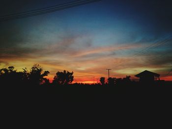 Silhouette trees against sky during sunset