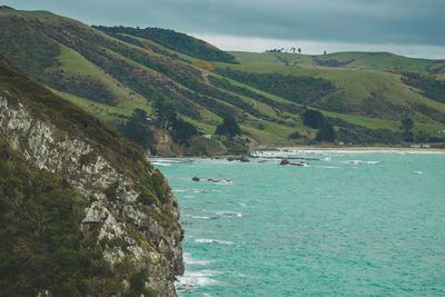 Scenic view of sea and mountains against sky