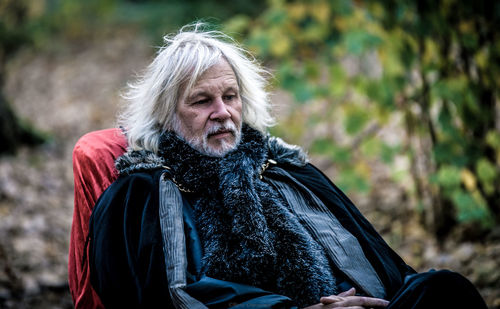 Portrait of mature man sitting outdoors