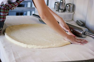 Midsection of woman preparing food in kitchen at home