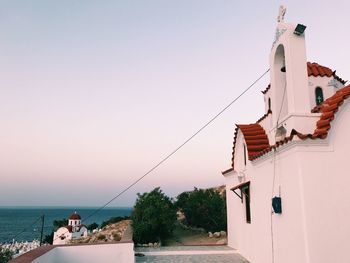 Low angle view of church at beach against clear sky