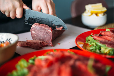 Cooking at home in kitchen italian carpaccio made from beef