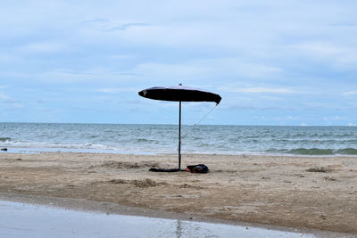 Lifeguard hut on beach against sky