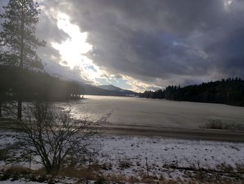 Scenic view of frozen lake against sky during winter