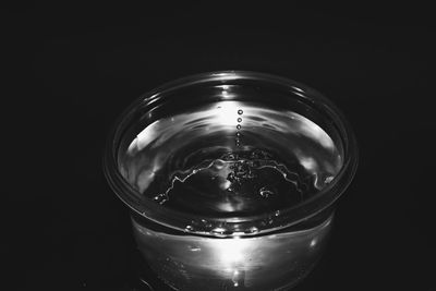Close-up of water in jar against black background