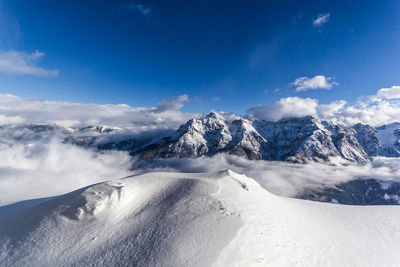 Scenic view of snowcapped mountains against sky