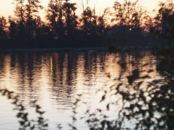 Scenic view of lake against sky at sunset