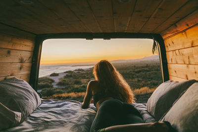 Rear view of woman sitting in car