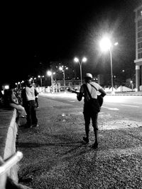 Blurred motion of people walking on road at night