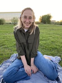 Portrait of teenage girl sitting on field