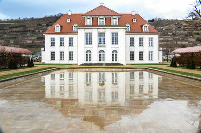 Castle reflecting on lake against sky