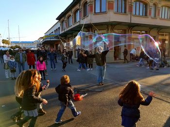 People standing in city against sky