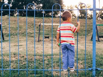 Man standing in front of chainlink fence