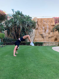 Full length of man jumping in park against sky