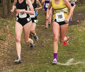 Low section of people running on grassland