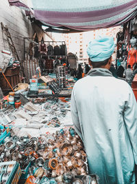 Rear view of a woman at market stall