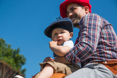 Father and son against hat