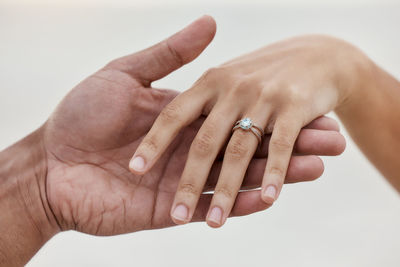 Close-up of hand against white background