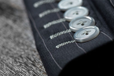 Close-up of blazer buttons on table