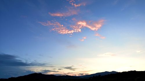 Scenic view of silhouette mountains against sky at sunset