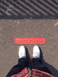 Low section of person standing on road