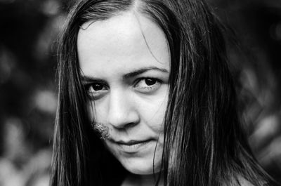 Close-up portrait of smiling young woman with injured face