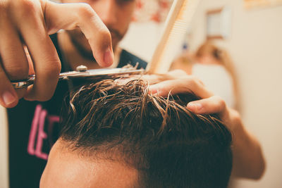 Barber cutting hair of man in the barber shop