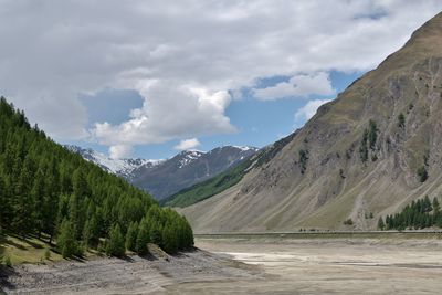 Scenic view of lake by mountains against sky