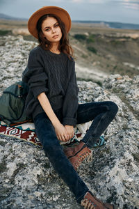 Young woman sitting on rock