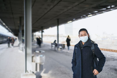 Portrait of woman standing in city