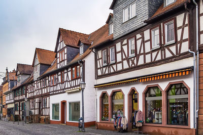 Street with historical half-timbered house in budingen, hesse, germany