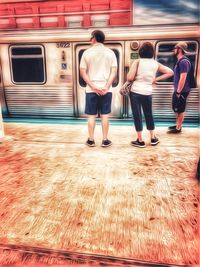 Rear view of people standing on train