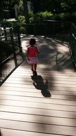 Full length of woman walking on footpath