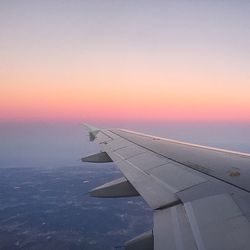 Cropped image of airplane flying over clouds