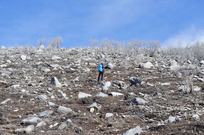 High angle view of man standing on land against sky
